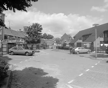 Gezicht op de achtergevels van de huizen Abstederdijk 61 (rechts midden) te Utrecht met rechts de achtergevels van de huizen aan de Marsstraat 17-23, met centraal parkeerplaatsen.